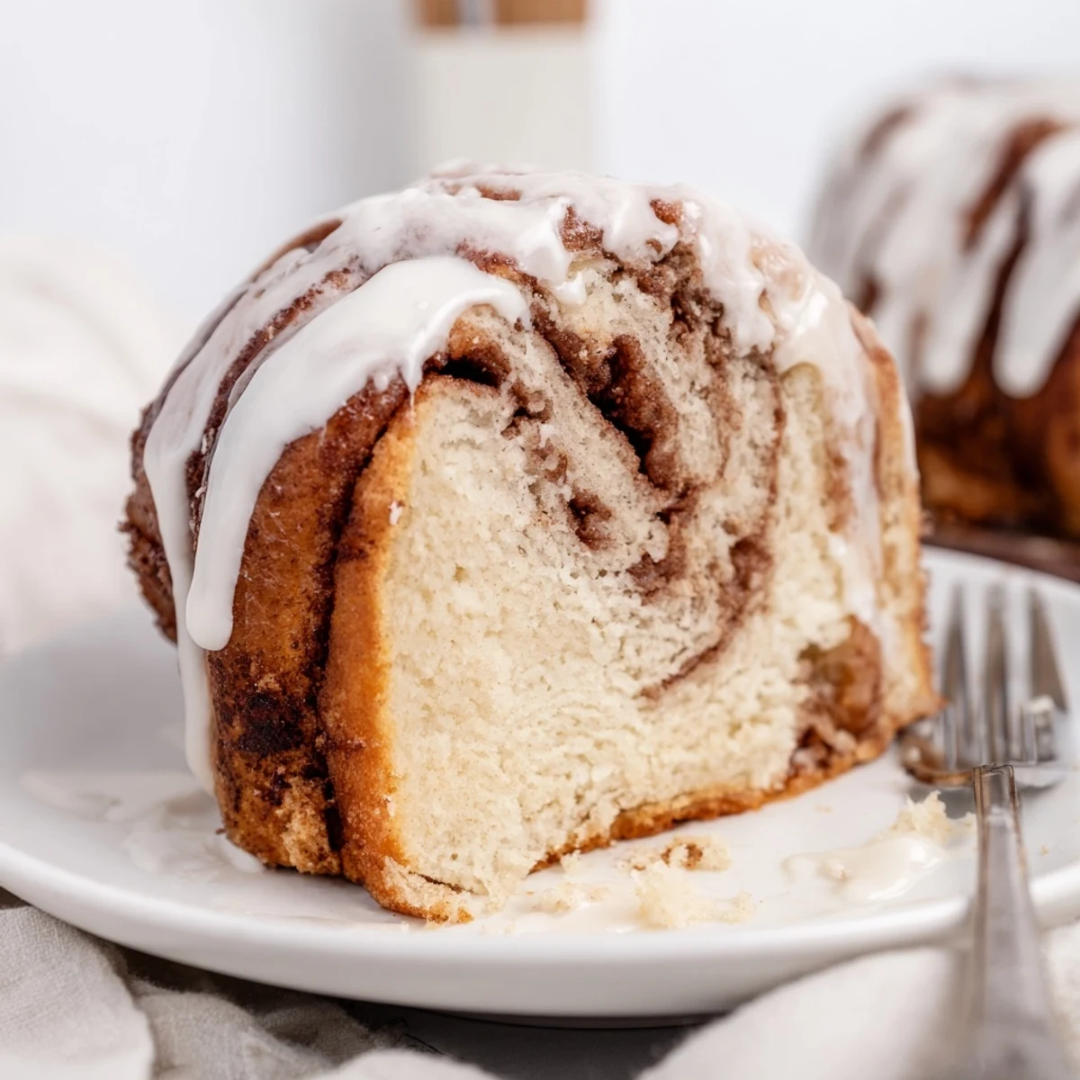 Buttery breakfast cake with marbled cinnamon sugar ribbons topped with sweet silky glaze