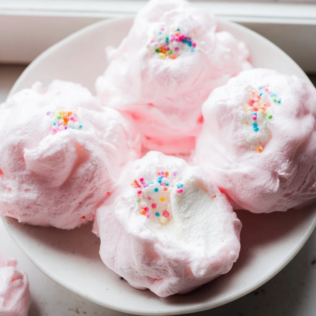 Mini Cotton Candy Cheesecake Puff Balls with fluffy pastel coating on a white serving plate