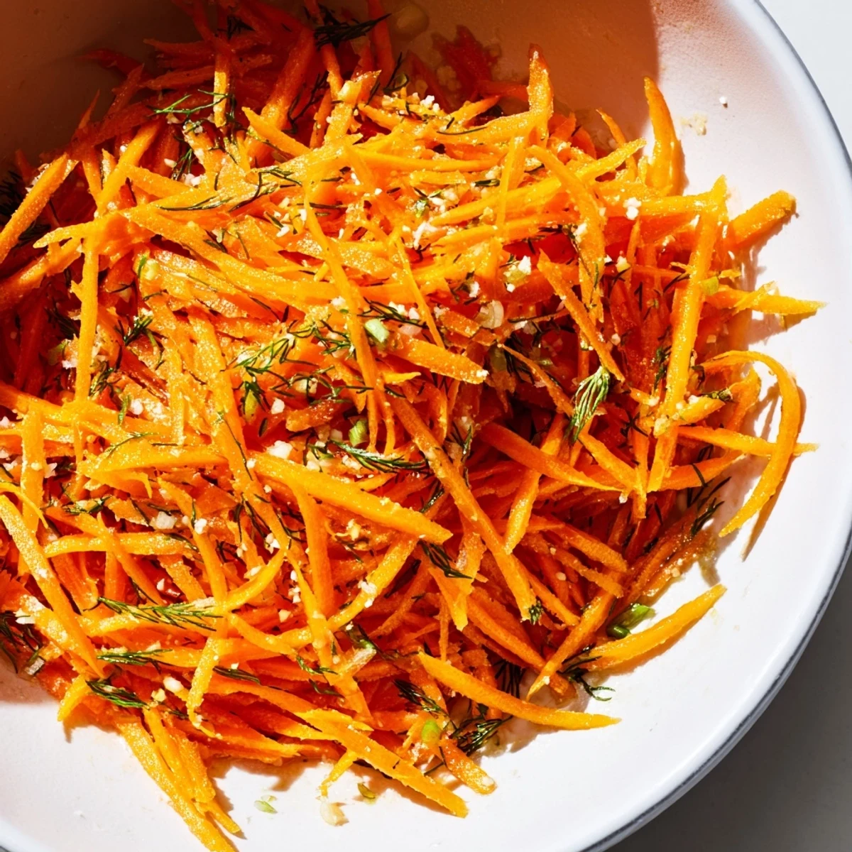 Crisp orange carrot ribbons tossed in bright lemon dill marinade ready for a refreshing summer side dish