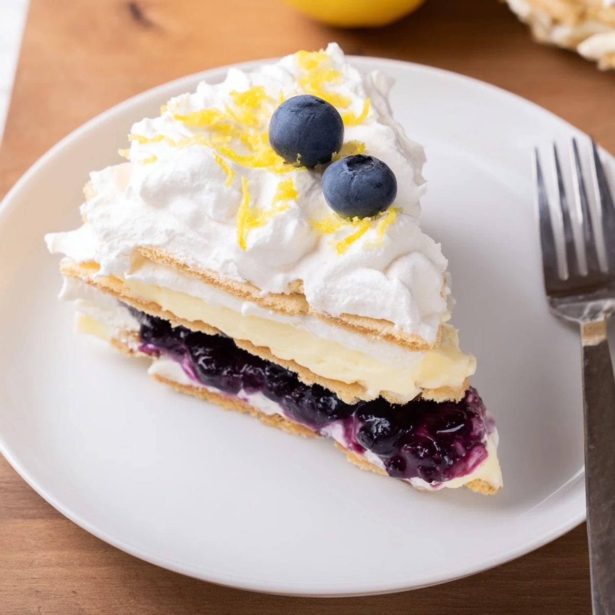 Chilled Lemon Blueberry Lasagna layered with buttery crust, tangy cream, juicy berries