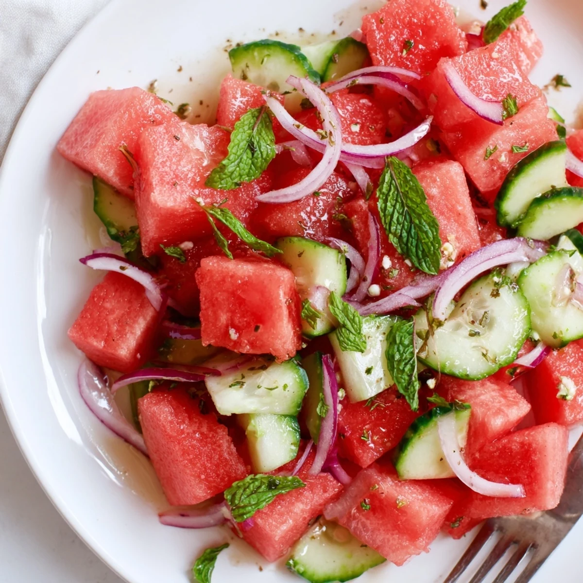 Chilled Watermelon Cucumber Salad topped with crumbled feta, refreshing summer side.