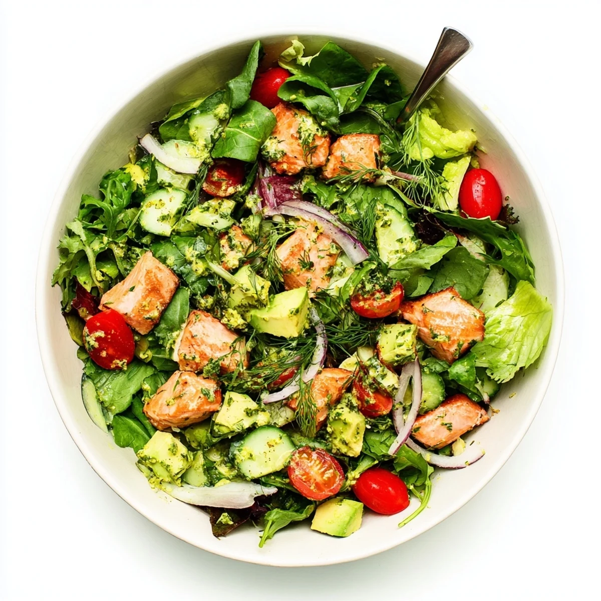 Flaky oven-roasted salmon salad featuring crisp cucumber, red onion, and tomatoes drizzled with zesty honey mustard dressing