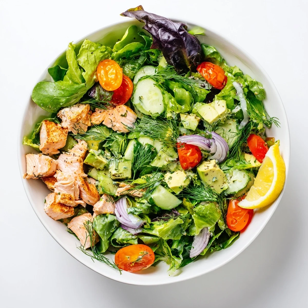 Colorful protein-packed ultimate salmon bowl with fresh dill, arugula, and tangy lemon garlic dressing for a healthy meal