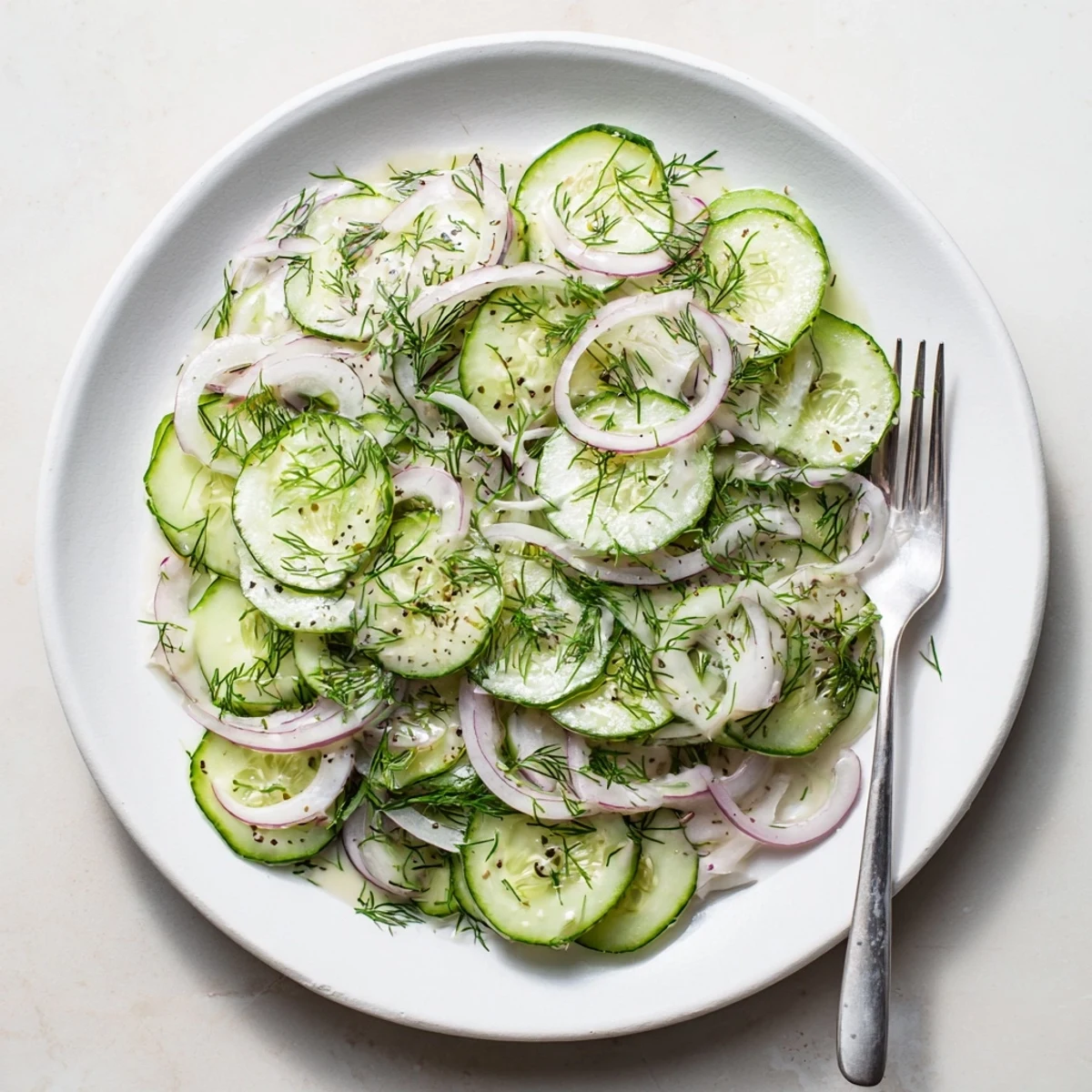 Crisp cucumber salad featuring fresh vegetables tossed in sweet and tangy apple cider vinegar dressing
