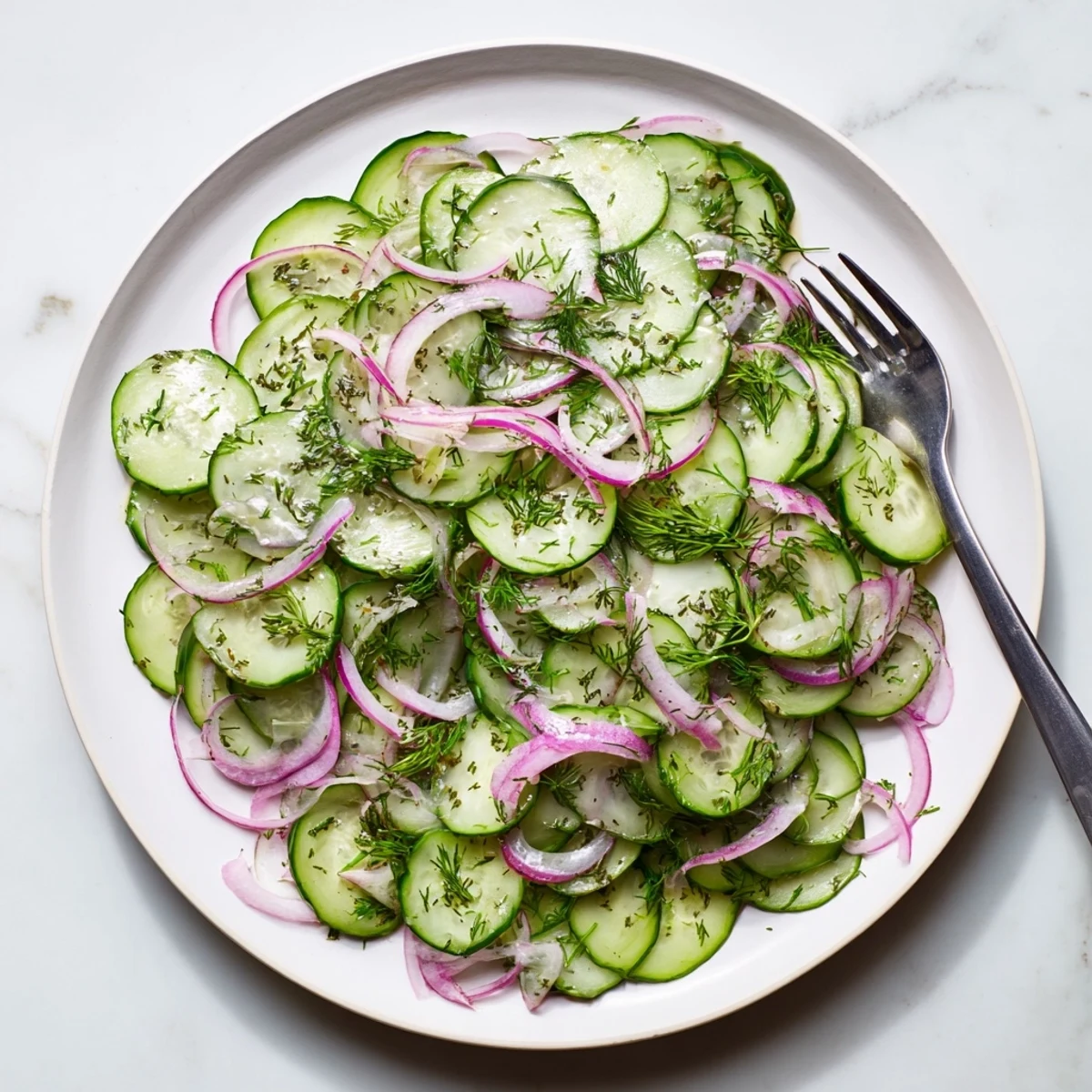 Garden fresh cucumber salad bowl showcasing crisp slices and bright red onions in light vinaigrette
