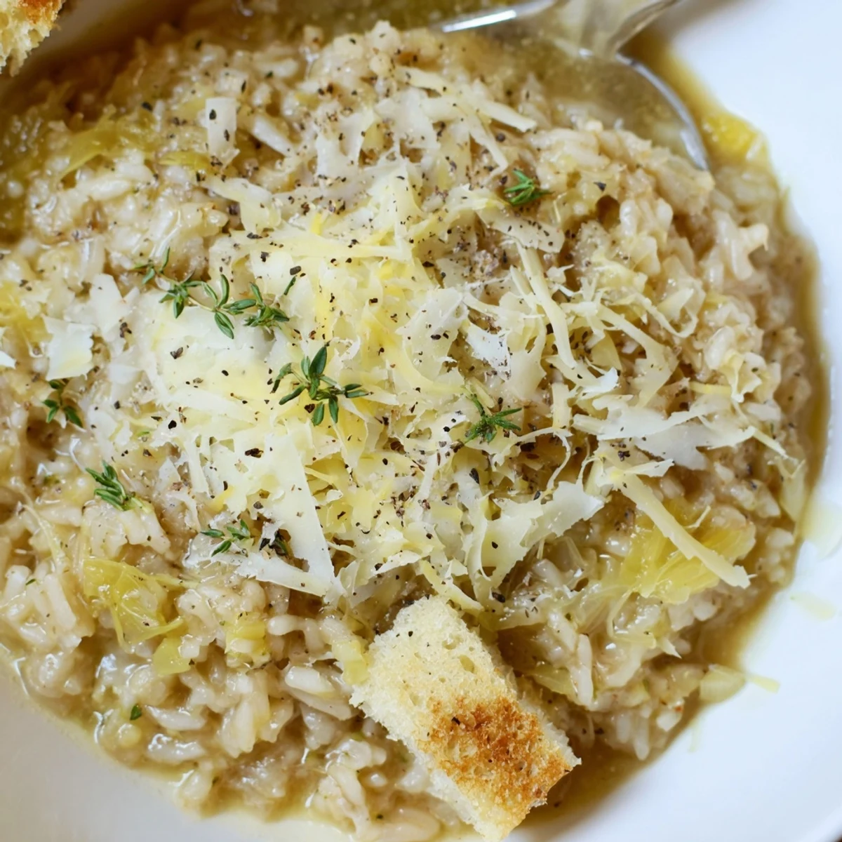 Hearty French Onion Soup Rice served steaming, creamy broth soaked rice, crisp topping