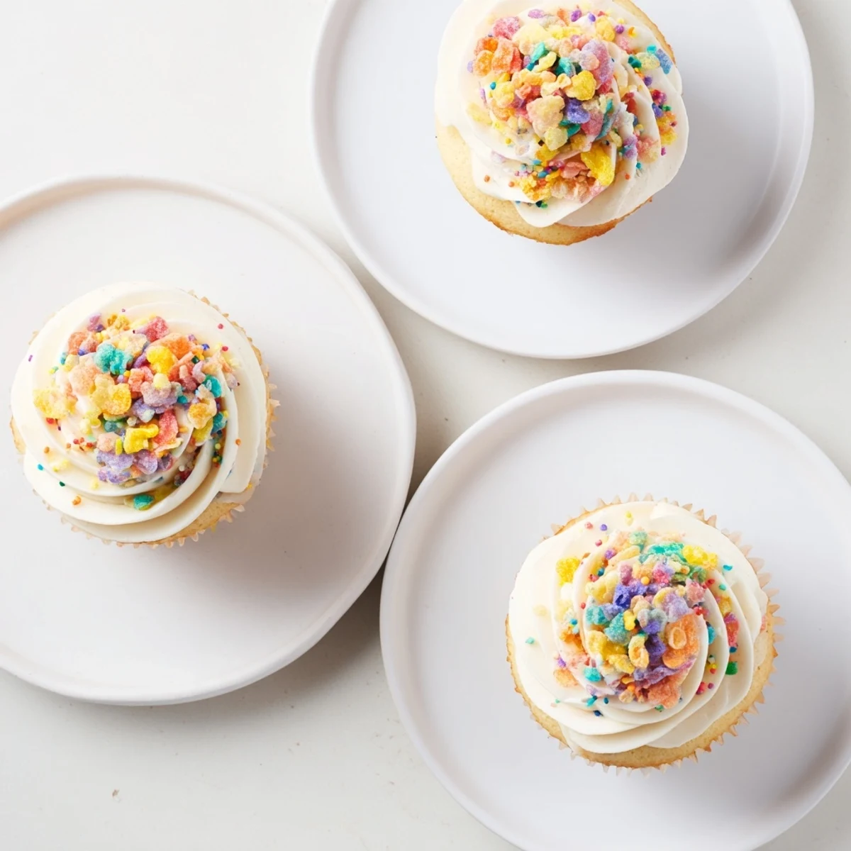 Bright Fruity Pebbles Cereal Frosting spread with a spatula; sweet aroma, joyful crunch