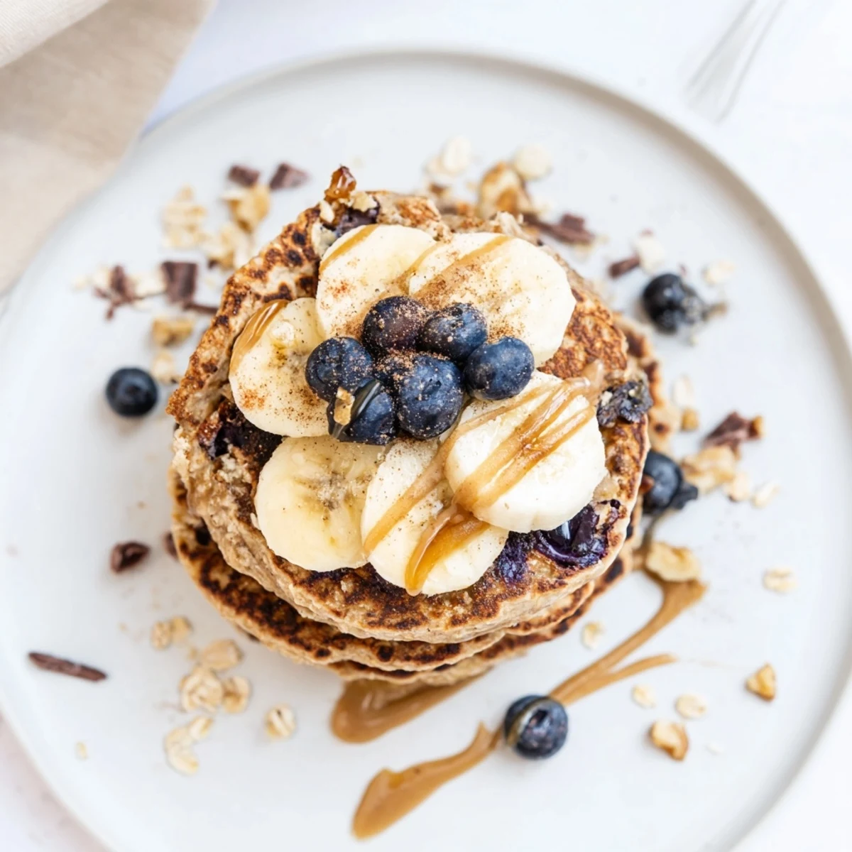 Close-up of warm Protein Banana Pancakes showing fluffy texture and melted butter