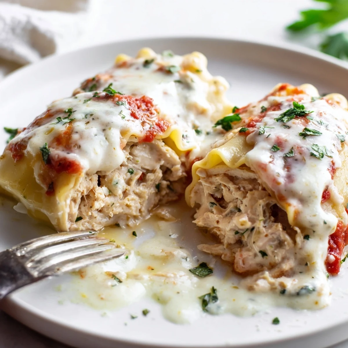 Golden Garlic Parmesan Chicken Lasagna Roll Ups bubbling with melted mozzarella in a baked casserole dish