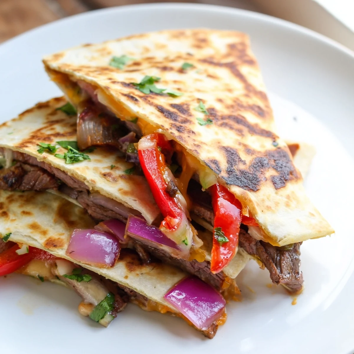 Sizzling steak quesadillas cut into triangles beside fresh guacamole and zesty salsa